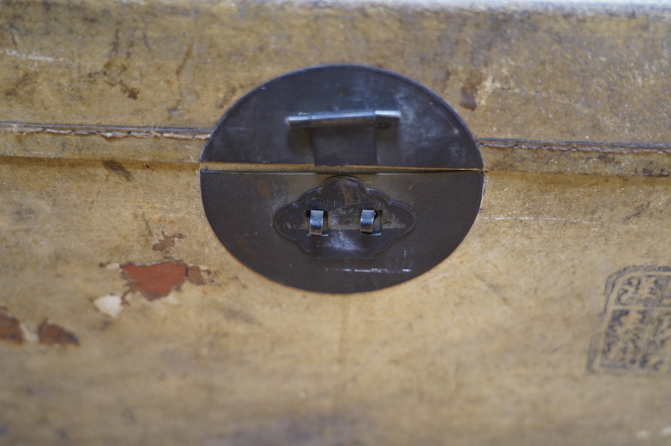 A vellum bound trunk, Chinese label to interior, 42cm wide, 24.5cm high. Condition - poor